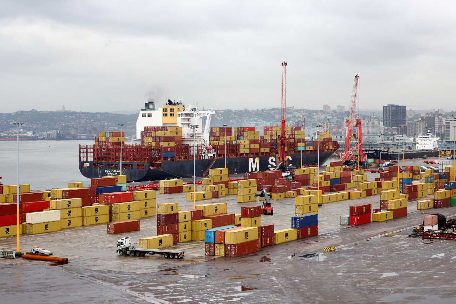 The MSC container ship is docked while a truck drives past containers at the Durban Harbour, in Durban, South Africa, February 7, 2025. REUTERS/Siphiwe Sibeko