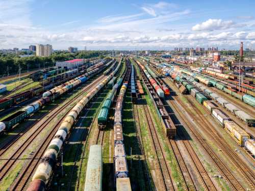 A railyard populated with numerous cargo trains