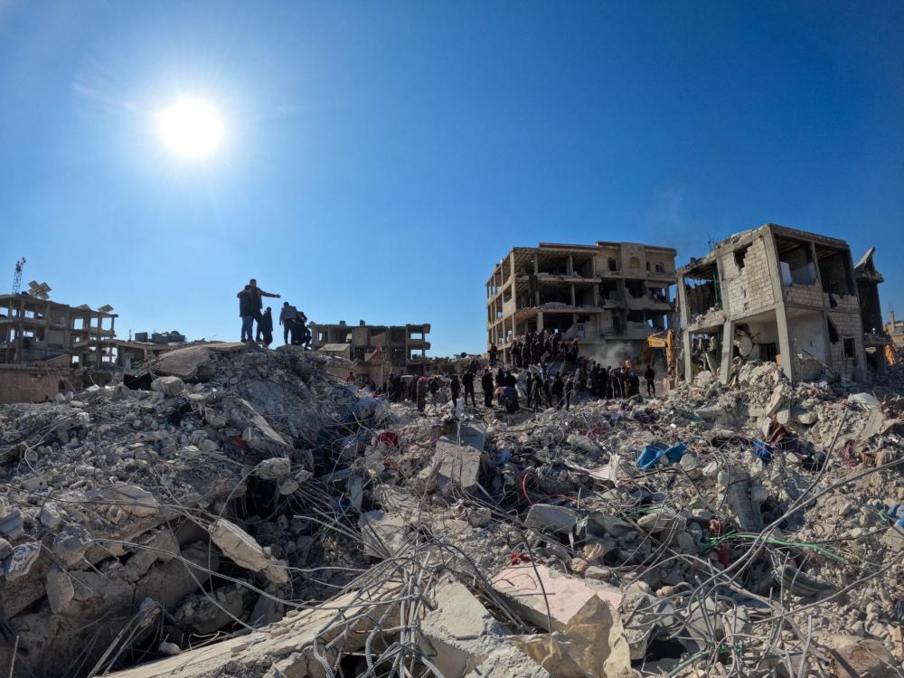 Rescue workers searching through the rubble of buildings in the rebel-held town of Jindayris on February 9, 2023, three days after a deadly earthquake that struck both Turkey and Syria.