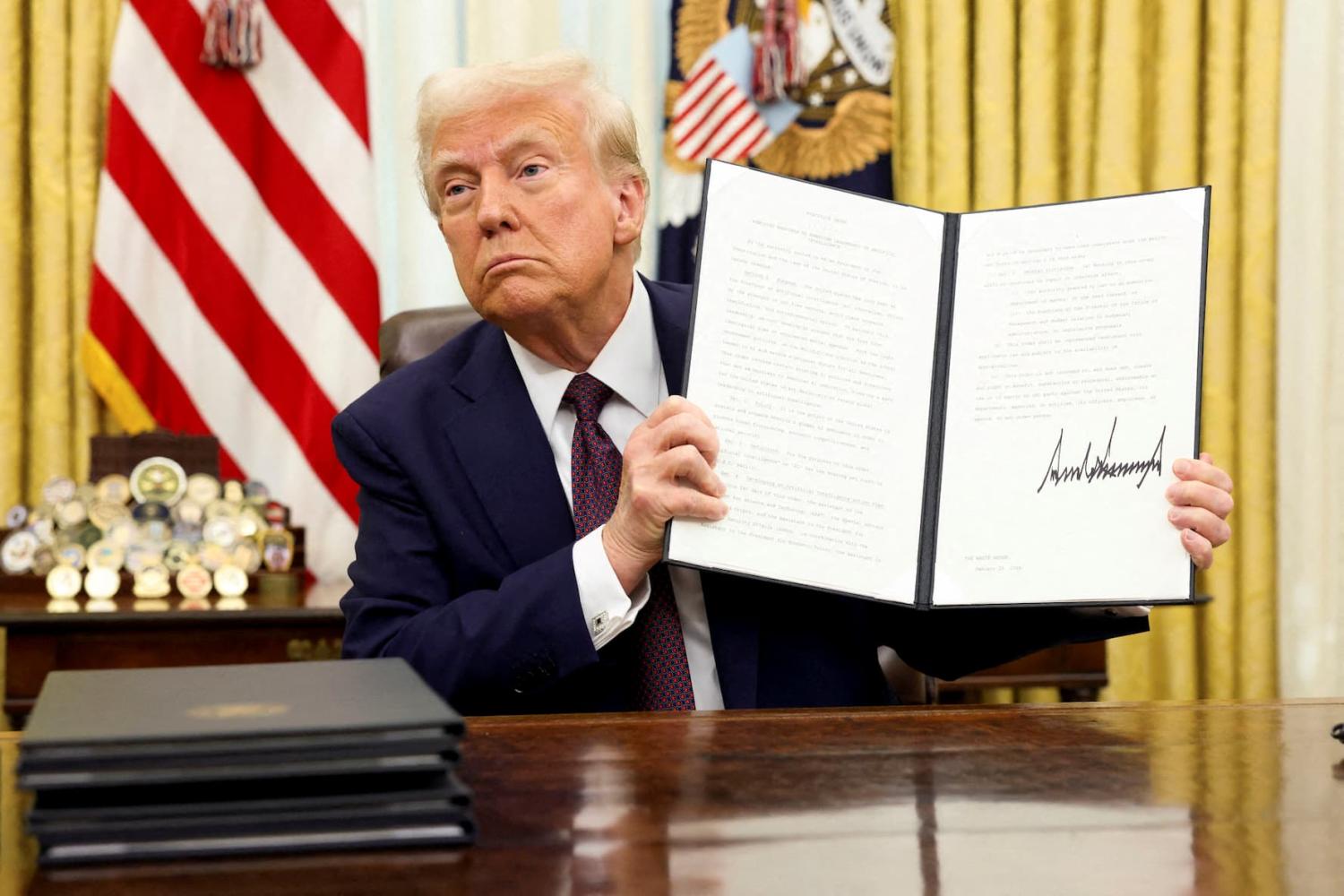 U.S. President Donald Trump holds a signed executive order on AI in the Oval Office of the White House, in Washington, U.S., on January 23, 2025.