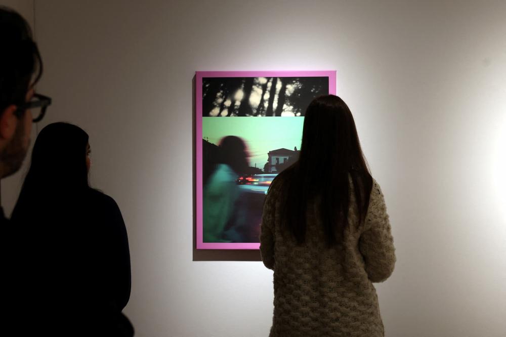 People look at Linda Dounia Rebeiz's 14° 40′ 34.46″ N 17° 26′ 15.14″ W, which is displayed during a preview for a first-ever AI-dedicated art sale at Christie's Auctions in New York City, U.S., February 5, 2025.