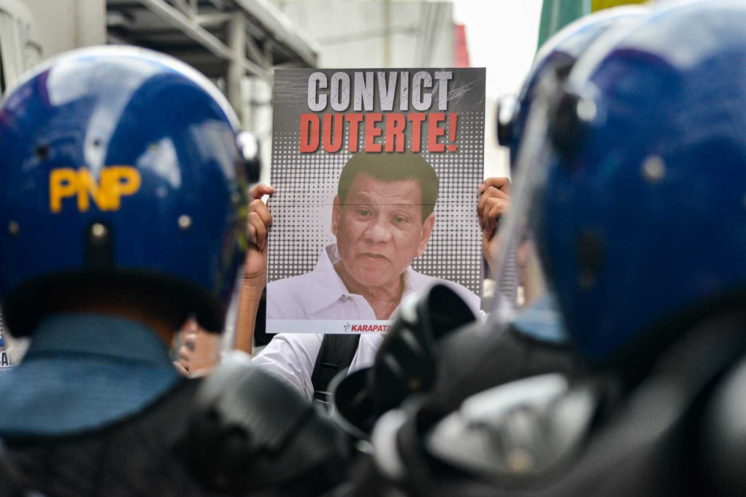 A picture of former President Rodrigo Duterte behind bars is displayed at a protest held by human rights advocates, on Recto Avenue on March 17, 2025, Manila, Philippines