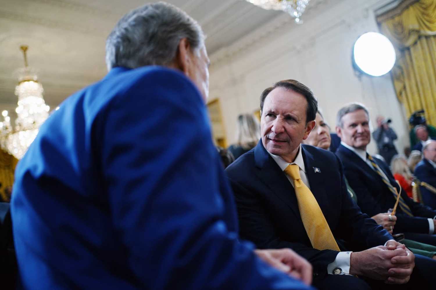 Louisiana Governor Jeff Landry (R) speaks to Texas Governor Greg Abbott before President Donald Trump signs an executive order calling on Education Secretary Linda McMahon to begin the process of dismantling the Department of Education at the White House in Washington, D.C., on Thursday, March 20, 2025.