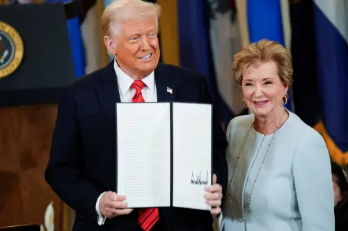 U.S. President Donald Trump reacts next to U.S. Secretary of Education Linda McMahon as he shows the executive order to shut down the Department of Education, in the East Room at the White House in Washington, D.C., U.S., on March 20, 2025.
