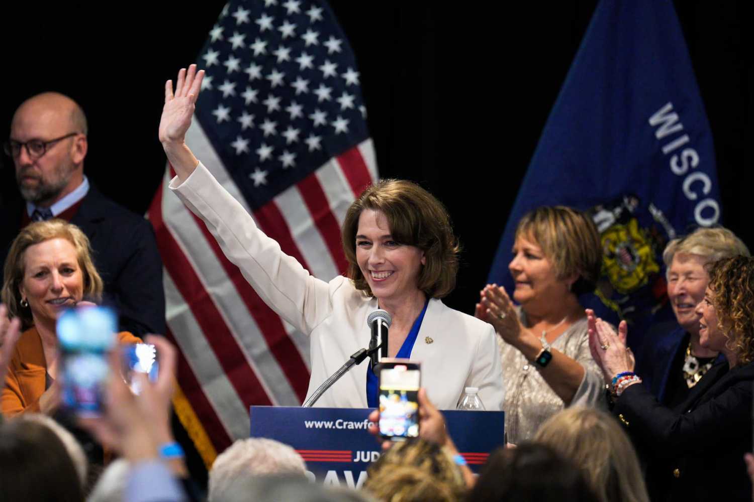 Susan Crawford waves to supporters at watch party after she beat Brad Schimel 54%-46% in a race for an open seat on the court in Madison, Wisconsin on March 30, 2025. The campaign was the most expensive state supreme court race in U.S. history, with expenditures topping in millions. Crawford's victory means that liberals will retain a 4-3 majority on the Wisconsin Supreme Court.