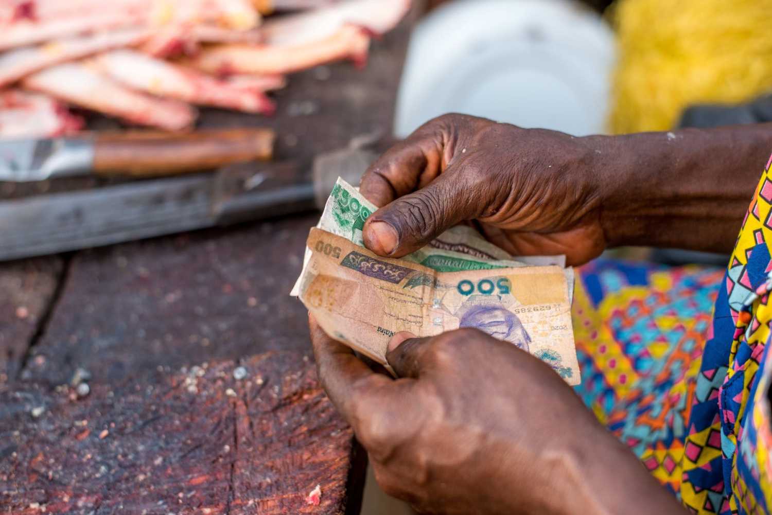 Hands holding Kenyan naira