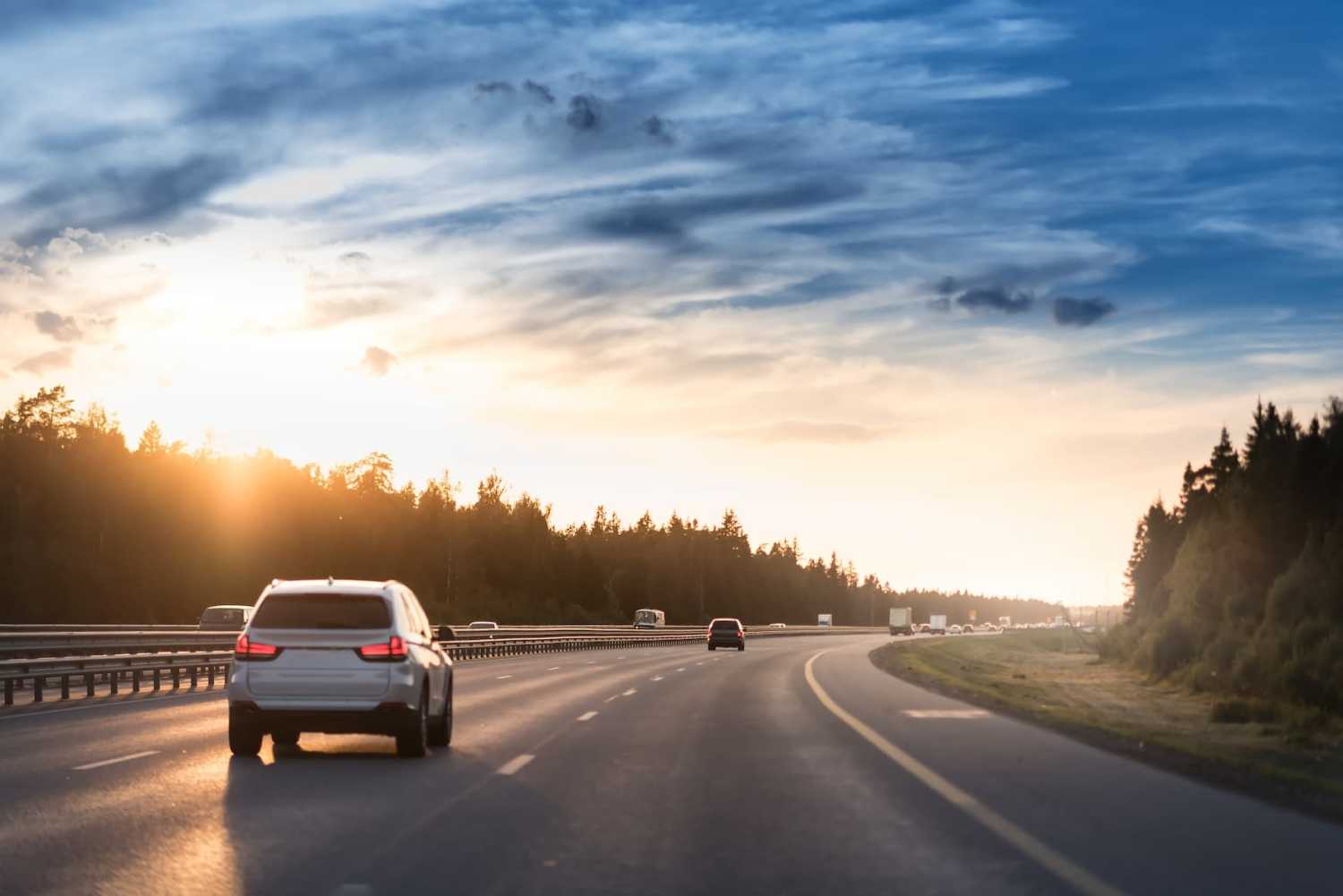 Highway traffic during sunset on cloudy day