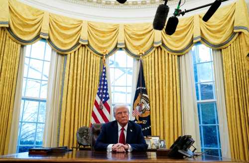 President Donald Trump sits at the Resolute Desk, where he signed executive orders in the Oval Office at the White House, Washington, D.C., January 30, 2025. REUTERS/Elizabeth Frantz