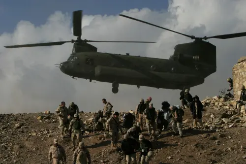 A Chinook helicopter hovers over U.S. troops in Afghanistan.