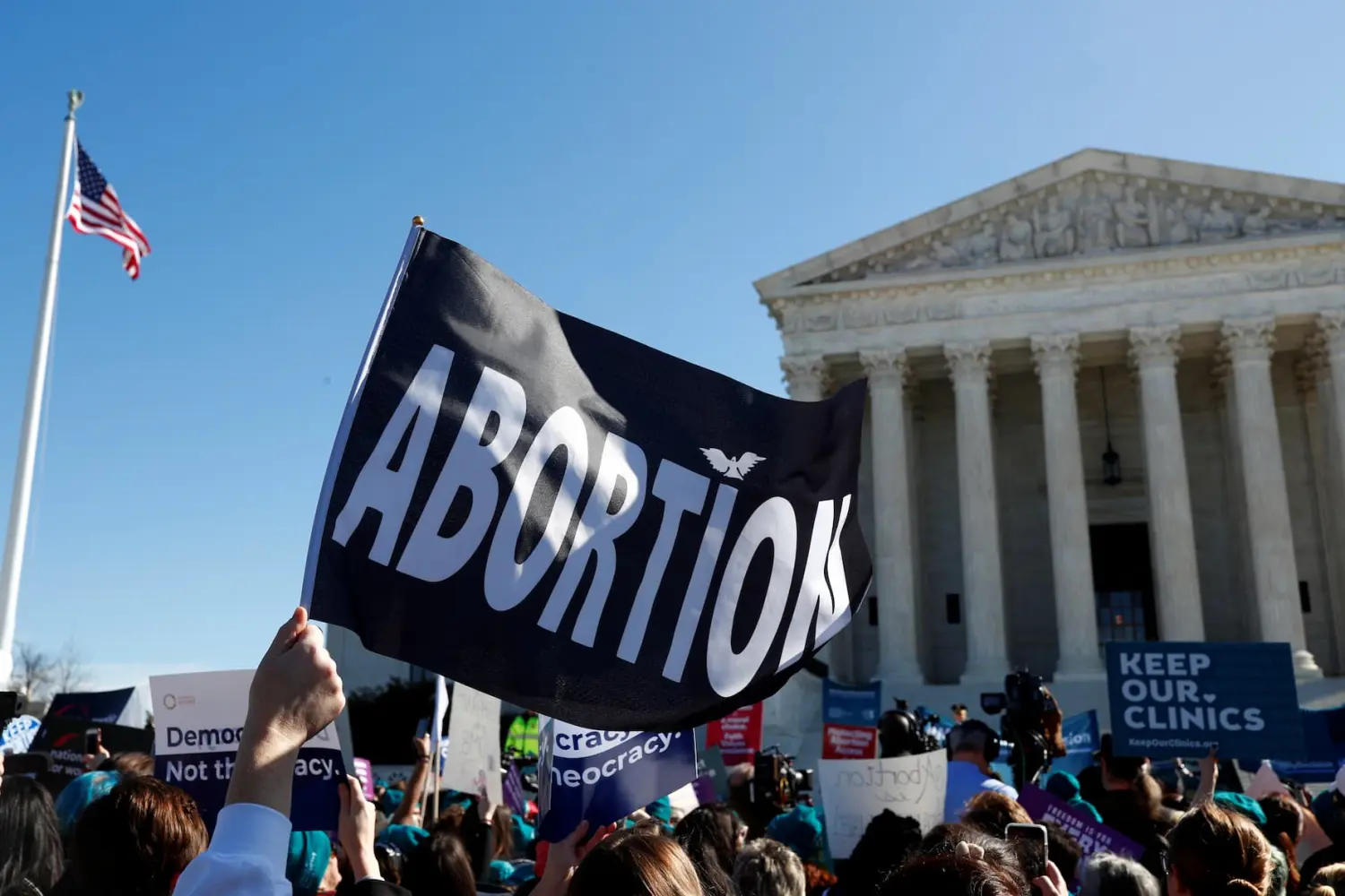 A demonstrator holds up an abortion flag outside of the U.S. Supreme Court as justices hear a major abortion case on the legality of a Republican-backed Louisiana law that imposes restrictions on abortion doctors, on Capitol Hill in Washington, U.S., March 4, 2020.