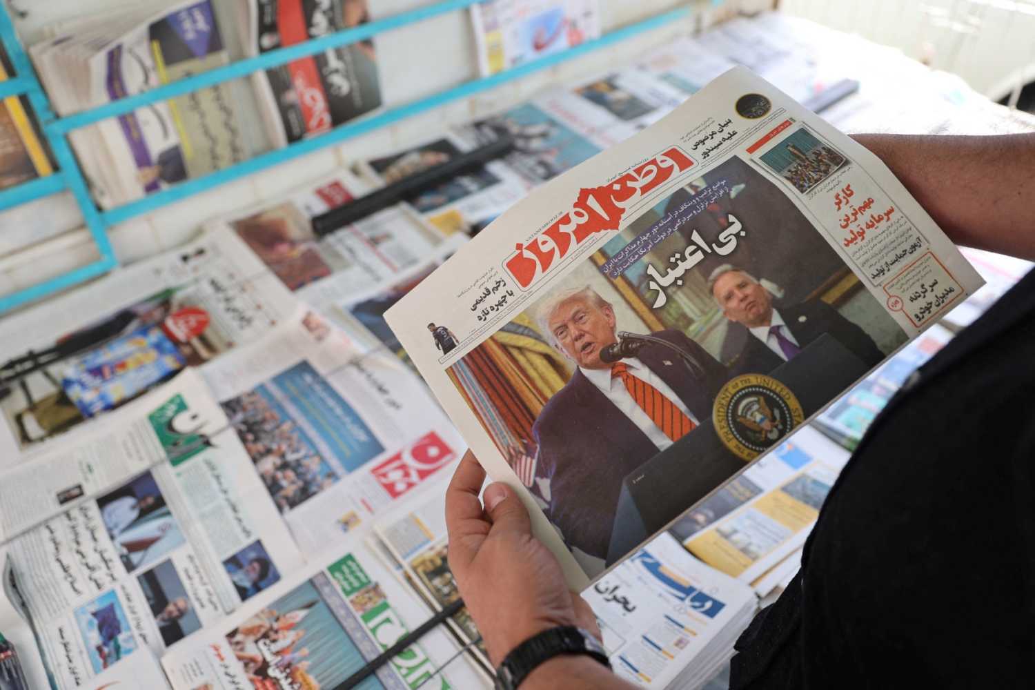 A man holds a newspaper with a cover photo of U.S. President Donald Trump and U.S. Middle East envoy Steve Witkoff, in Tehran, Iran, May 11, 2025.