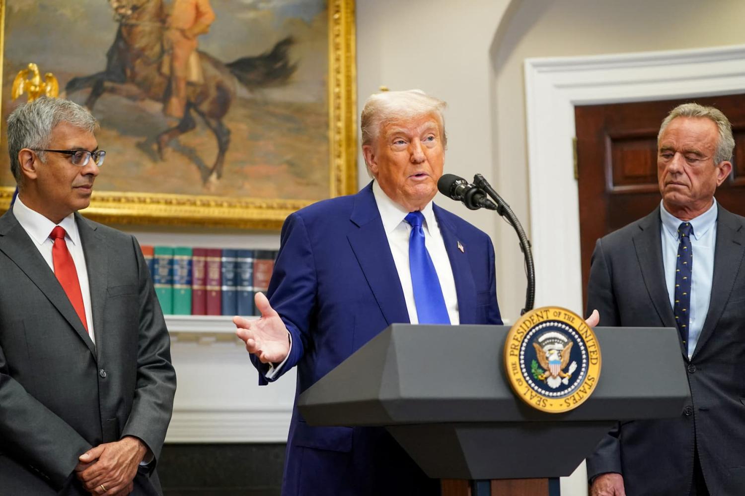 U.S. President Donald Trump, Director of the National Institute of Health Jay Bhattacharya, and Health and Human Services (HHS) Secretary Robert F. Kennedy Jr. attend a press conference in the Roosevelt Room at the White House in Washington, D.C., U.S., on May 12, 2025.