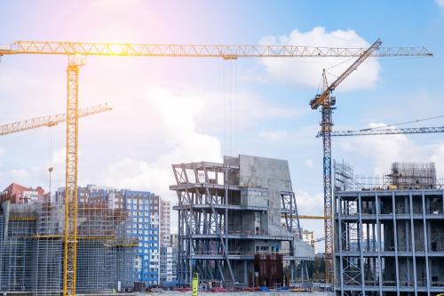A,Crane,And,A,Building,Under,Construction,Against,A,Blue