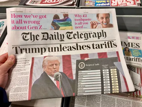 A photo of front page of The Daily Telegraph newspaper with headline "Trump unleashes tariffs." Shutterstock/Steve Travelguide