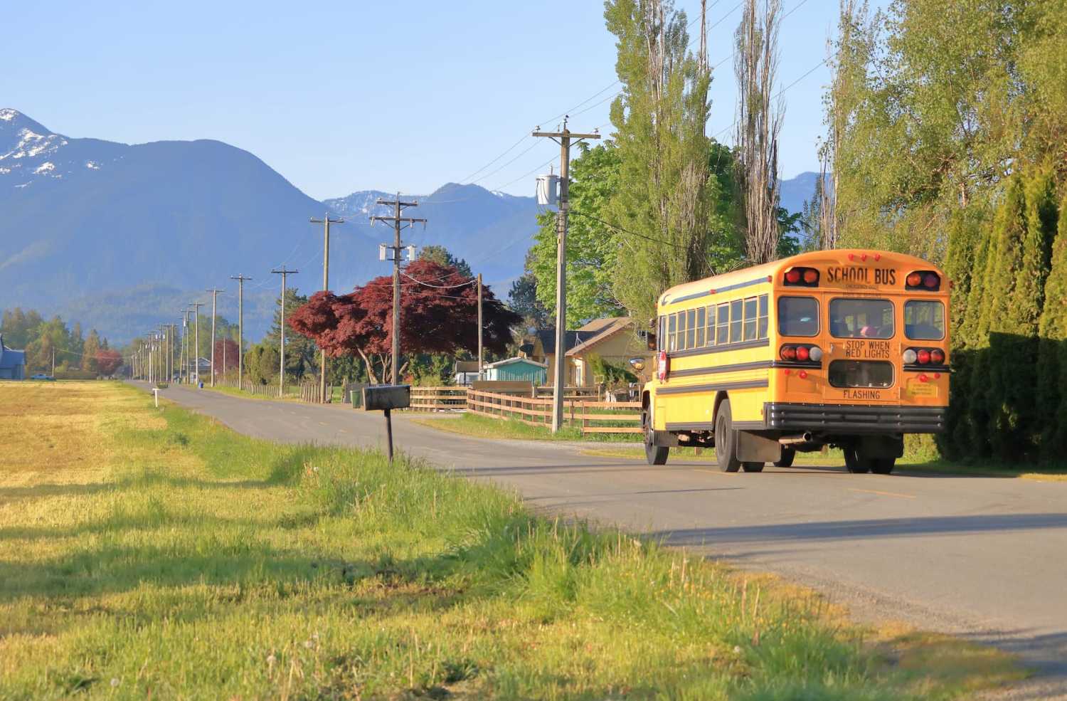 A school bus drives through a country road in an agricultural valley on July 10, 2019.