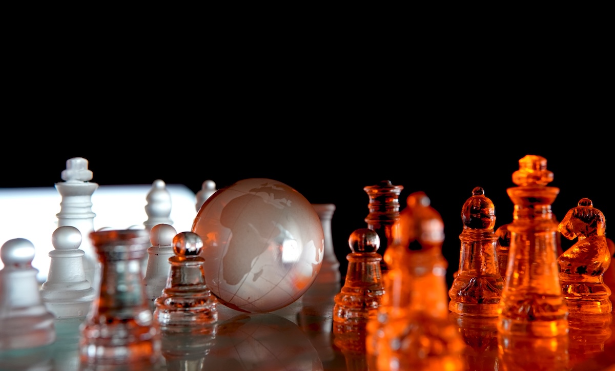 A globe showing Africa amid chess pieces.