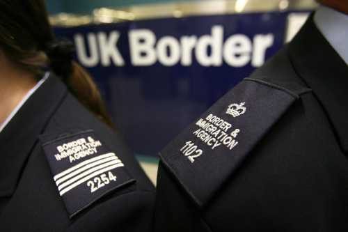Immigration officers pictured wearing brand new uniforms at Gatwick's border control. PA Images via Reuters Connect.