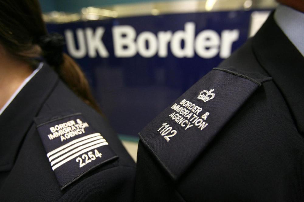 Immigration officers pictured wearing brand new uniforms at Gatwick's border control. PA Images via Reuters Connect.