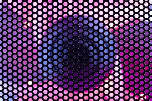 A close-up of a gaming PC case shows a fan illuminated by RGB LED lighting and covered with a protective mesh, highlighting the intersection of cooling, lighting, and PC network technology.