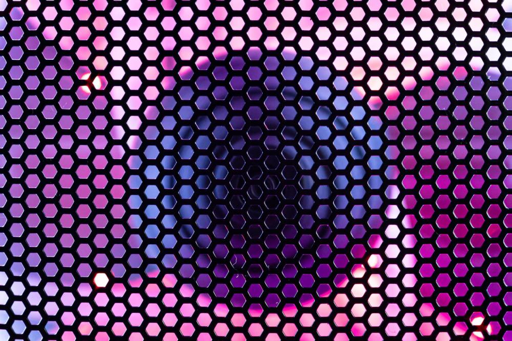 A close-up of a gaming PC case shows a fan illuminated by RGB LED lighting and covered with a protective mesh, highlighting the intersection of cooling, lighting, and PC network technology.