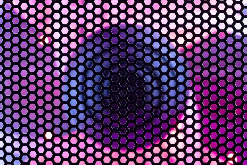 A close-up of a gaming PC case shows a fan illuminated by RGB LED lighting and covered with a protective mesh, highlighting the intersection of cooling, lighting, and PC network technology.