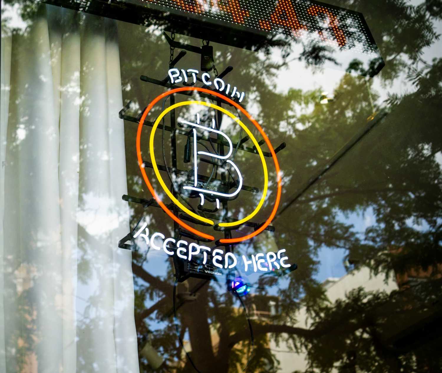 Bitcoin accepted here is displayed in the window of a store in the East Village in New York on Saturday, May 15, 2021.