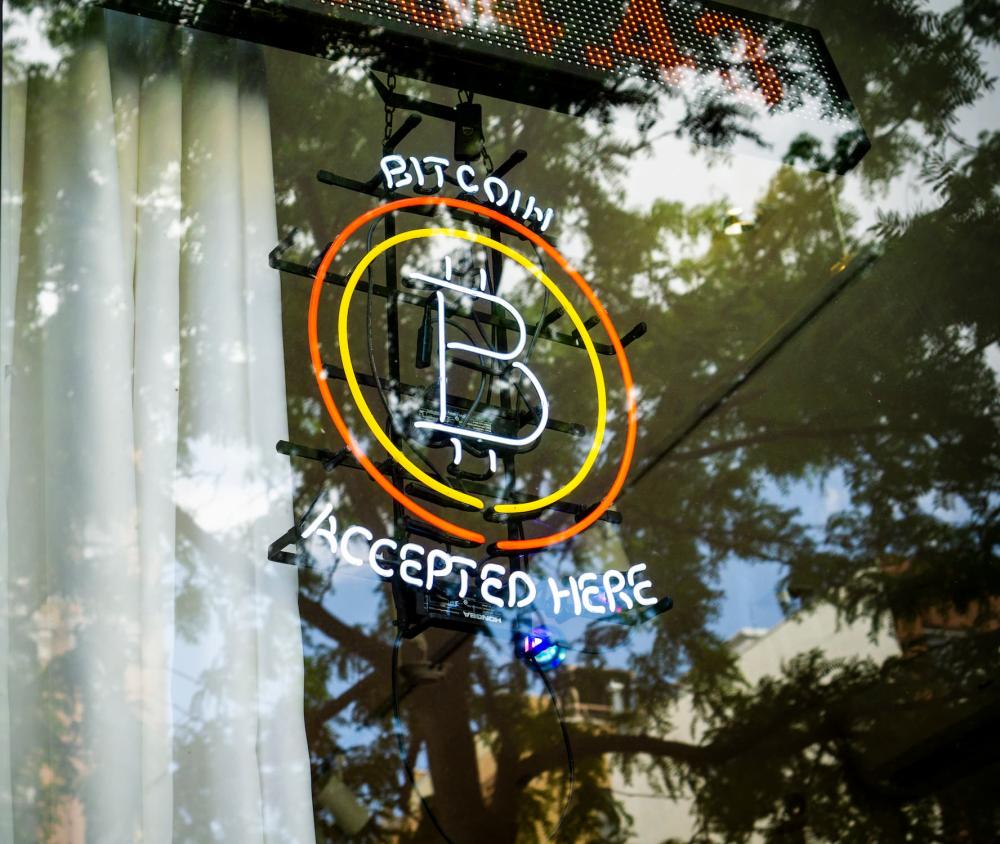 Bitcoin accepted here is displayed in the window of a store in the East Village in New York on Saturday, May 15, 2021.