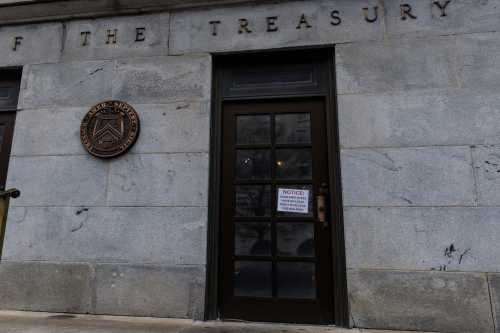 A sign alleging Department of Government Efficiency (DOGE) employees cannot legally enter the Treasury Department is seen on the outside doors of the Treasury Building in Washington, D.C. on Saturday, February 8, 2025. A federal judge ruled to restrict the Elon Musk-run DOGE program's access to the Treasury's trillion dollar payment processing systems.