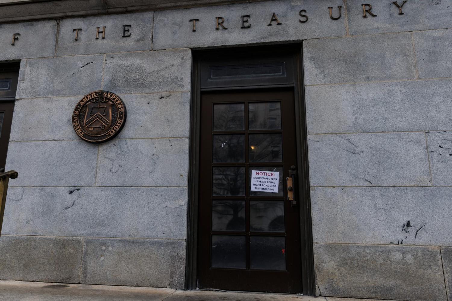 A sign alleging Department of Government Efficiency (DOGE) employees cannot legally enter the Treasury Department is seen on the outside doors of the Treasury Building in Washington, D.C. on Saturday, February 8, 2025. A federal judge ruled to restrict the Elon Musk-run DOGE program's access to the Treasury's trillion dollar payment processing systems.