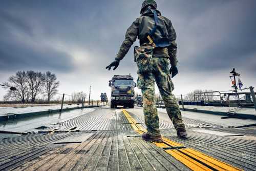 A soldier hand signals to the truck driver as he guides him to the parking during the exercise of 101st Engineer Battalion.