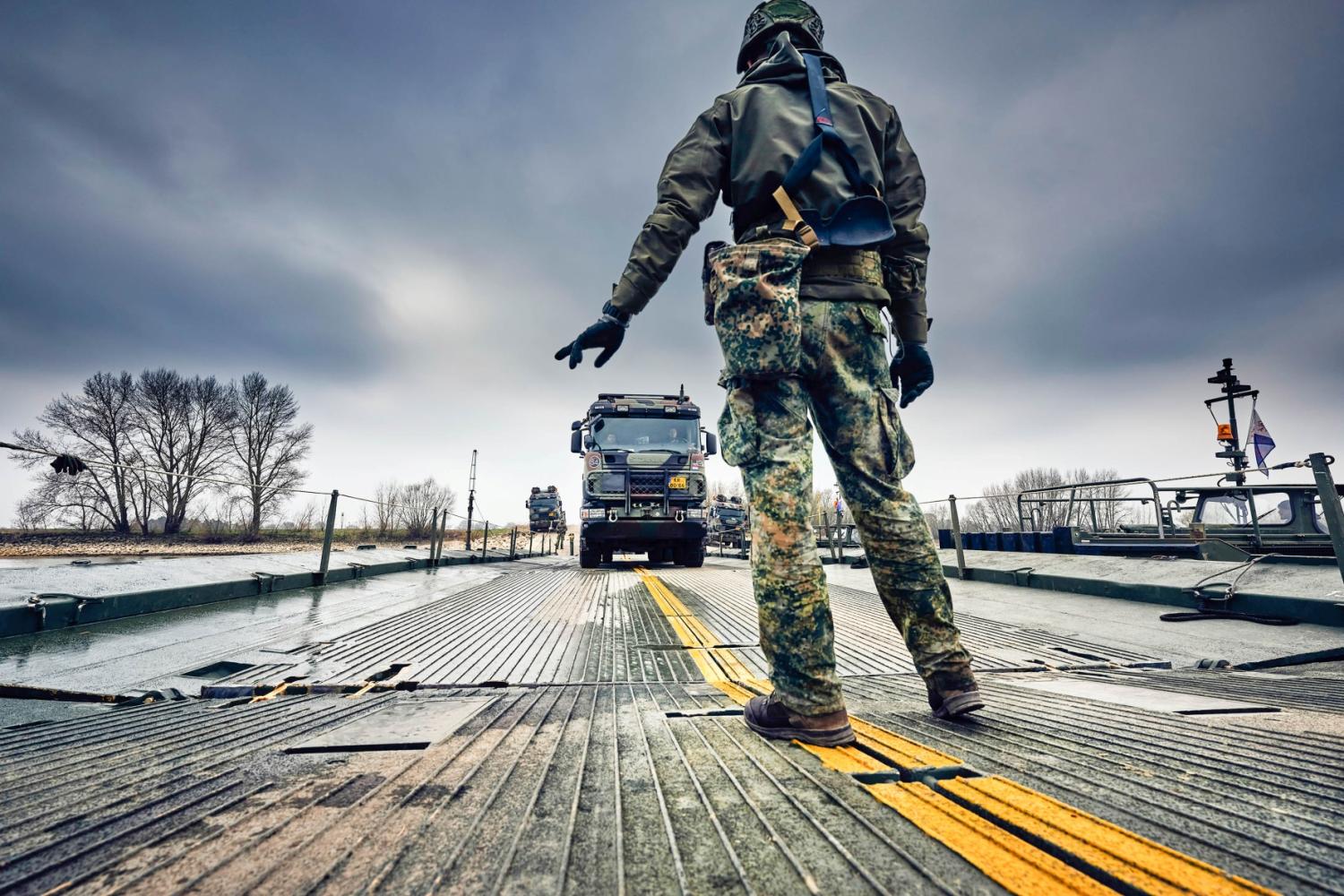 A soldier hand signals to the truck driver as he guides him to the parking during the exercise of 101st Engineer Battalion.