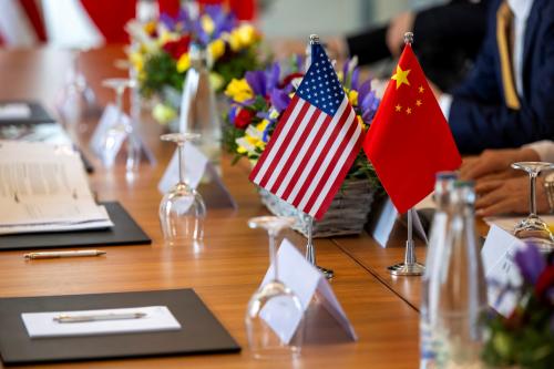 The American and Chinese flags are photographed on the negotiating table, during a bilateral meeting between the United States and China, in Geneva, Switzerland, May 10, 2025.