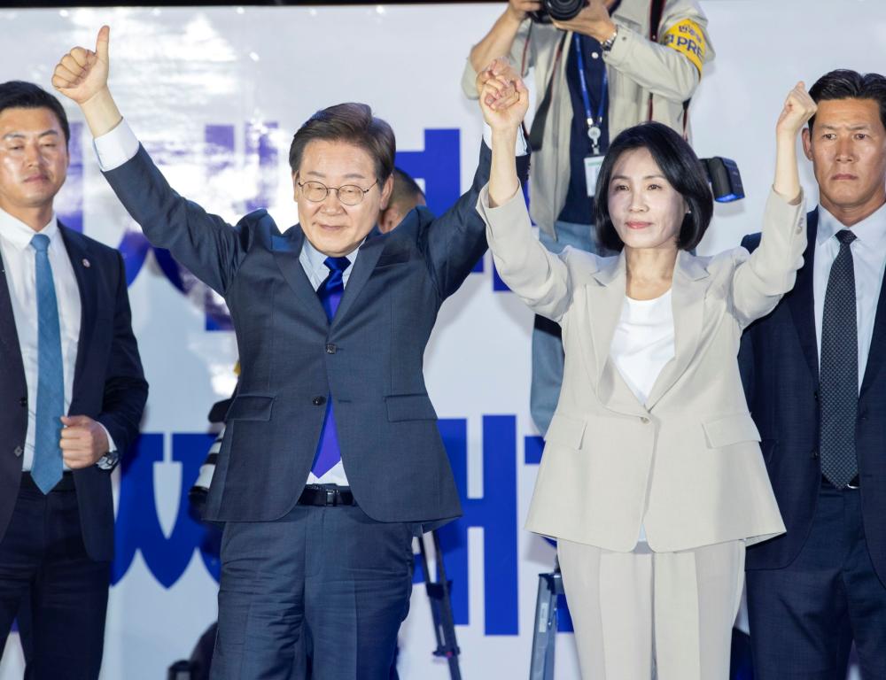 South Korea’s Democratic Party presidential candidate Lee Jae-myung (Left) and his wife Kim Hye-gyeong, thanks supporters during a celebration party to announce his victory in the presidential election, front of the National Assembly, in Seoul, South Korea on June 4, 2025.