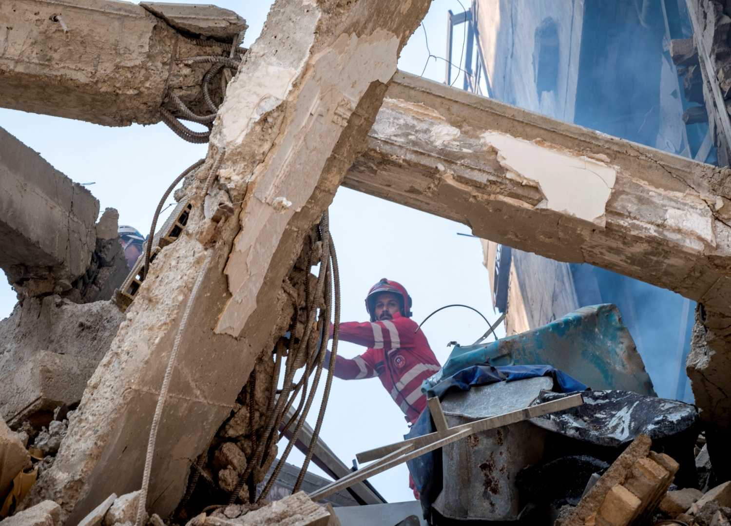 An Iranian firefighter works at the scene of a destroyed residential building caused by Israeli attacks in Tehran, Iran, on June 13, 2025.