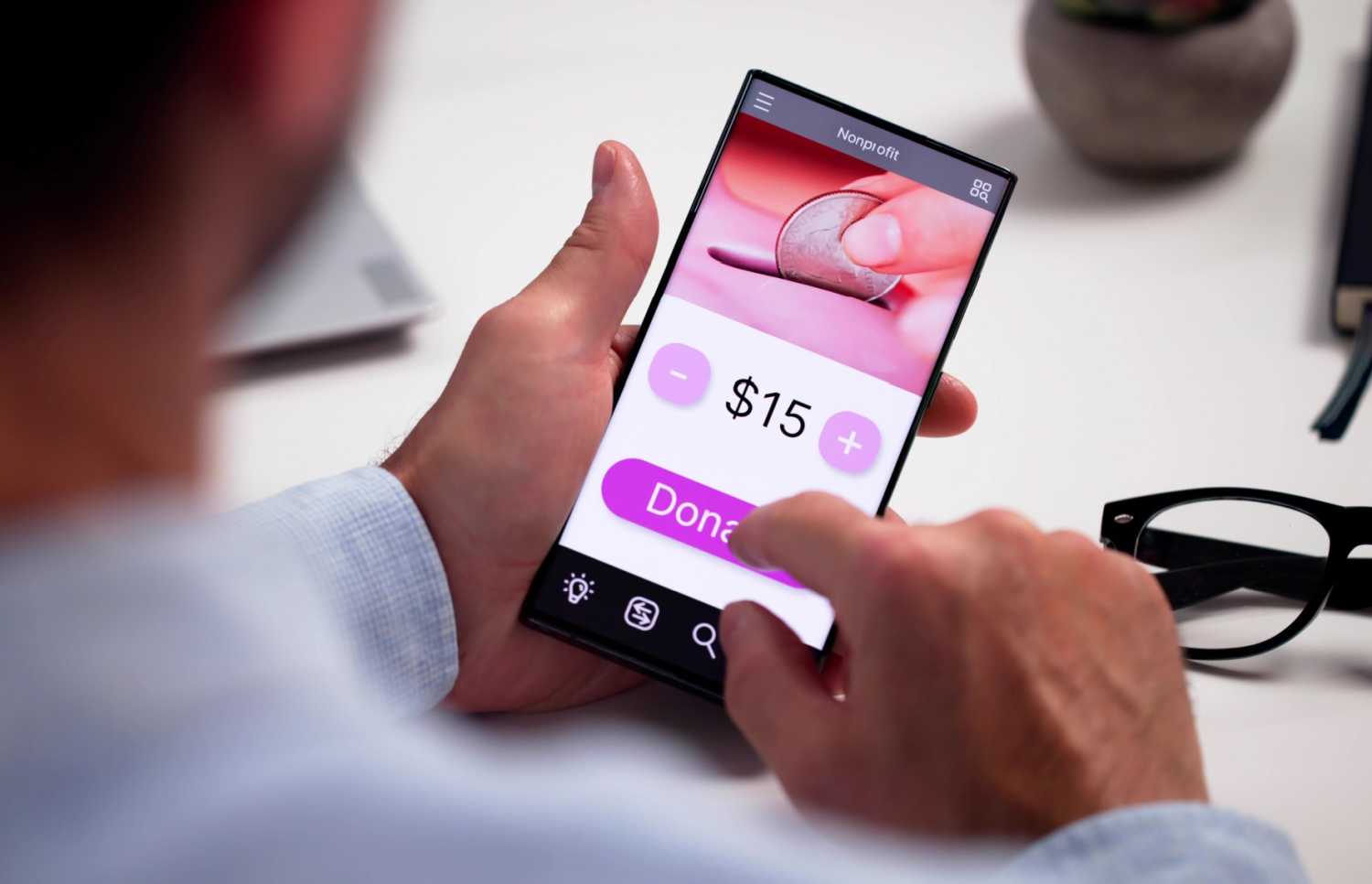 Man making donation on smart phone.