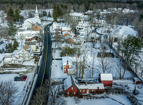 Aerial view of a small town blanketed with now