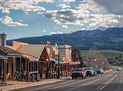 Storefronts against a scenic mountain backdrop