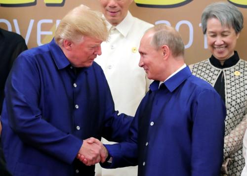 U.S. President Donald Trump and Russian President Vladimir Putin shake hands as they take part in a family photo at the APEC summit in Danang, Vietnam November 10, 2017.