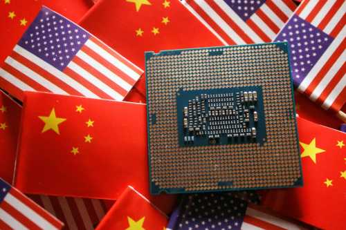 A central processing unit (CPU) semiconductor chip is displayed among flags of China and U.S., in this illustration picture taken February 17, 2023.