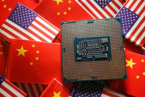 A central processing unit (CPU) semiconductor chip is displayed among flags of China and U.S., in this illustration picture taken February 17, 2023.