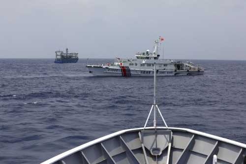 A Chinese Coast Guard ship is seen blocking the direction of a Philippine Coast Guard ship conducting a resupply mission for Filipino troops stationed at a grounded warship in the South China Sea, October 4, 2023.