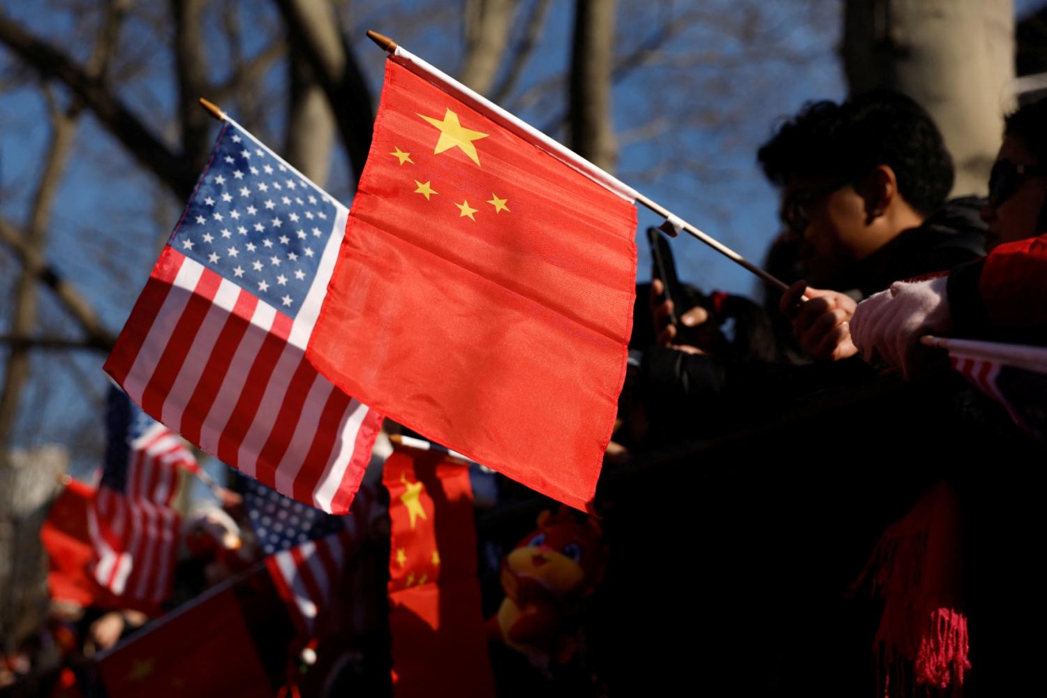 People hold U.S. and China flags as they attend a celebration of the Lunar New Year, in the Chinatown section of Manhattan in New York City, U.S., January 29, 2025.