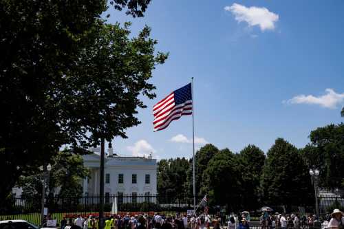 A group protests outside the White House against Trump's visa ban on refugees and immigrants who come to the U.S. for school in Washington, D.C., on June 20, 2025.