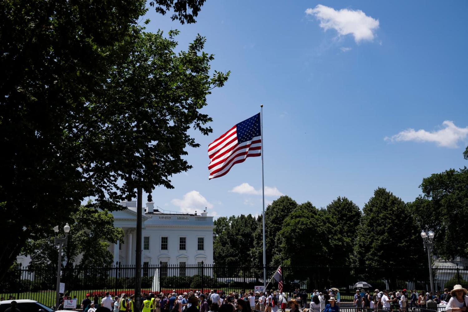 A group protests outside the White House against Trump's visa ban on refugees and immigrants who come to the U.S. for school in Washington, D.C., on June 20, 2025.