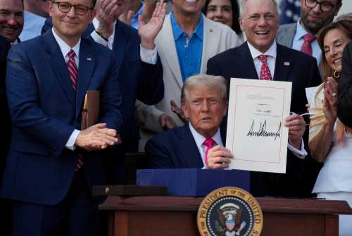 U.S. President Donald Trump presents a sweeping spending and tax legislation, known as the "One Big Beautiful Bill Act," after he signed it, at the White House in Washington, D.C, U.S., on July 4, 2025.