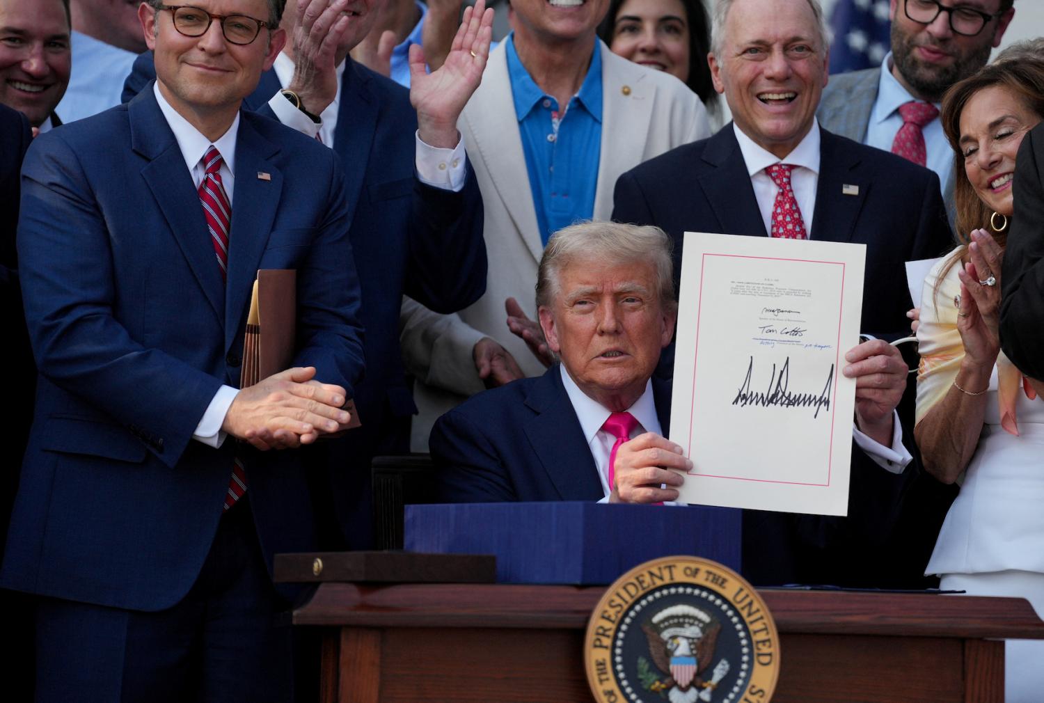U.S. President Donald Trump presents a sweeping spending and tax legislation, known as the "One Big Beautiful Bill Act," after he signed it, at the White House in Washington, D.C, U.S., on July 4, 2025.