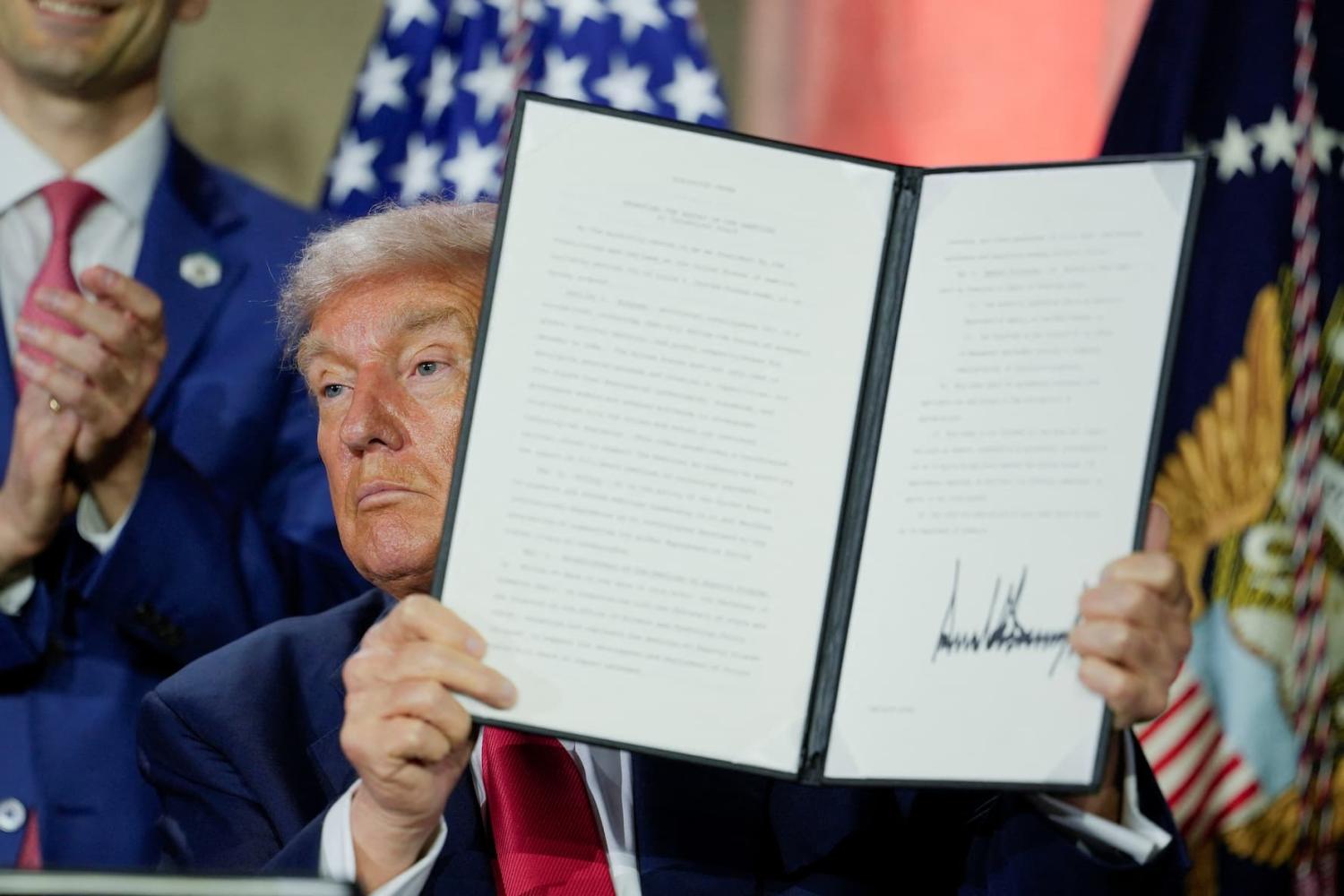 U.S. President Donald Trump holds an executive order related to AI after signing it during the "Winning the AI Race" Summit in Washington D.C., U.S., July 23, 2025.
