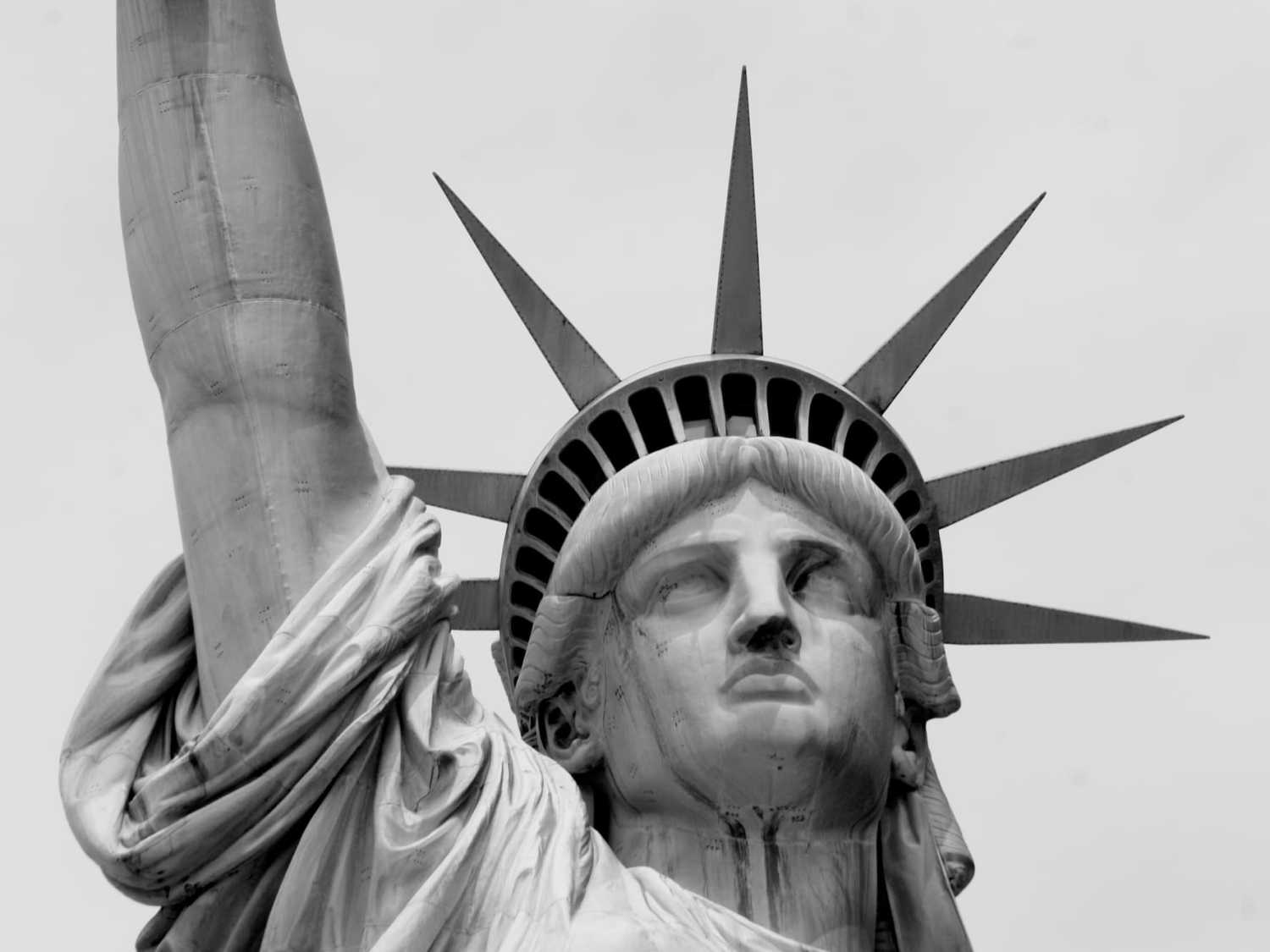 The Statue of Liberty seen up close, rendered in black and white.