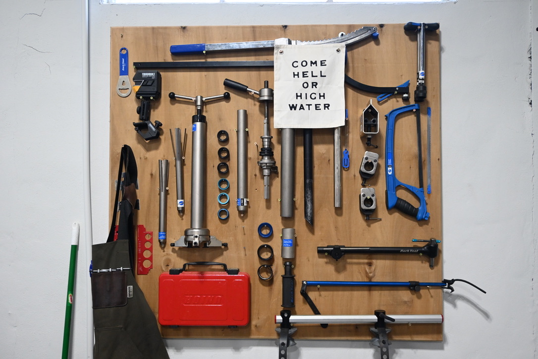 Sign and tools in Old Fort Bike Shop, Old Fort, North Carolina, June 2025. (Photo by Molly Born)