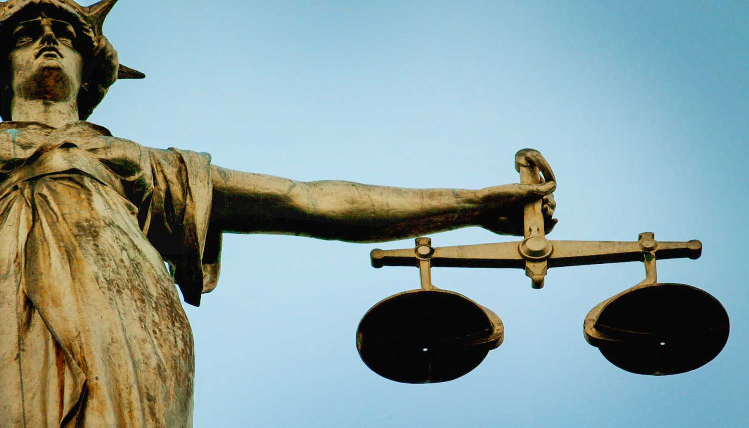A statue holding the scales of justice is seen on top of the Old Bailey in London, on December 12, 2003.